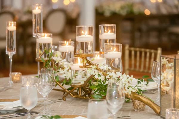 A spring wedding reception table dressed with seasonal florals and fine place settings.